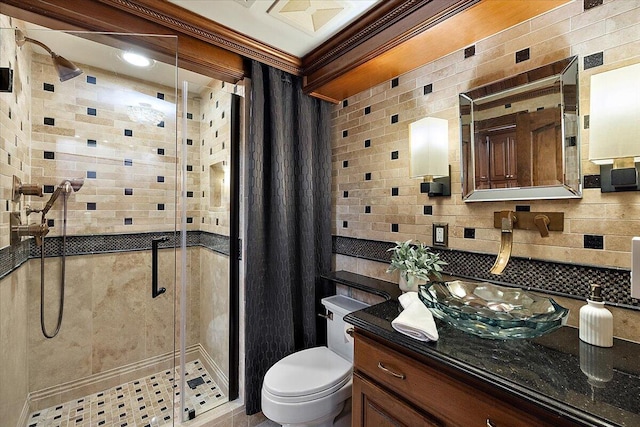 full bathroom featuring toilet, a shower stall, backsplash, and vanity