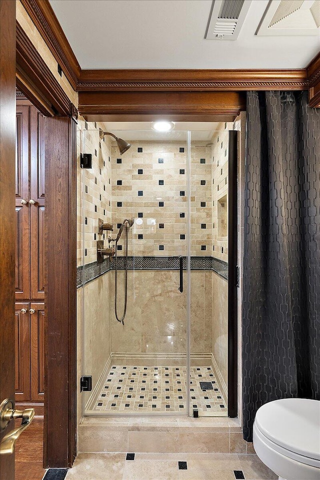 full bath featuring toilet, a stall shower, and visible vents