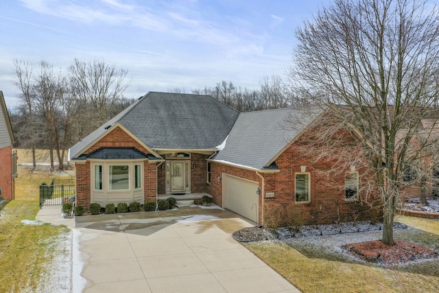 craftsman house with a garage, brick siding, driveway, and a shingled roof