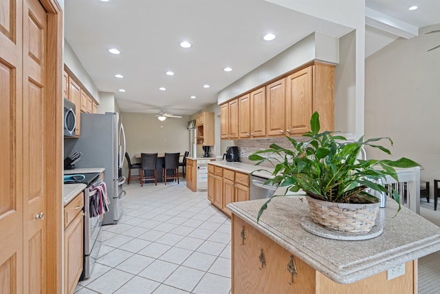 kitchen with light tile patterned floors, recessed lighting, light countertops, backsplash, and appliances with stainless steel finishes