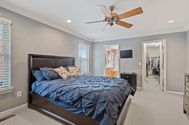 bedroom with baseboards, visible vents, a walk in closet, and crown molding