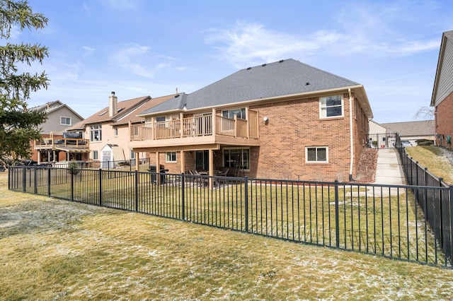 back of property with a residential view, brick siding, a lawn, and a fenced backyard