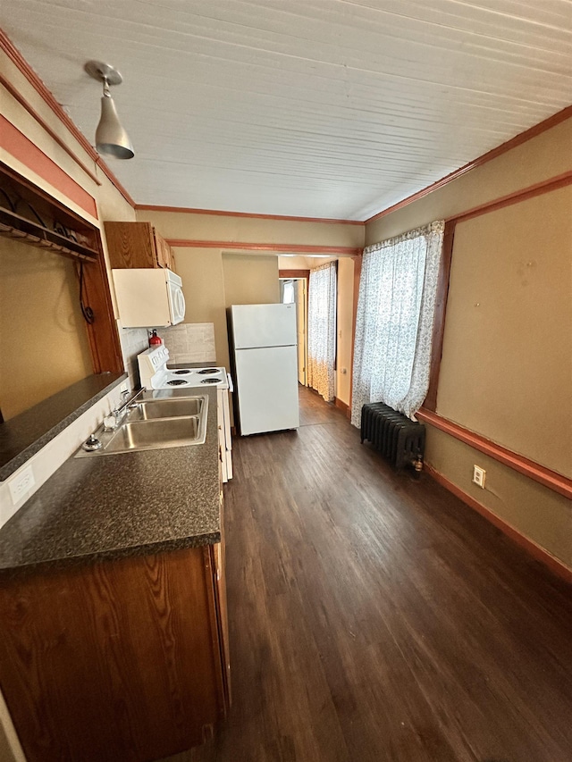 kitchen featuring white appliances, dark wood-style flooring, a sink, baseboards, and radiator