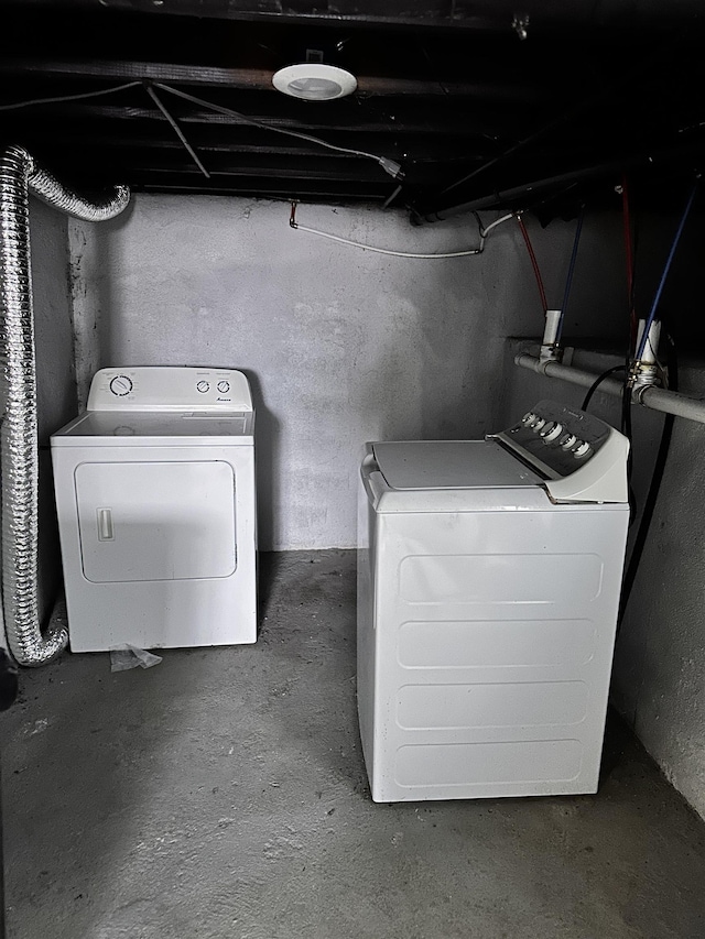 clothes washing area featuring laundry area and washing machine and clothes dryer