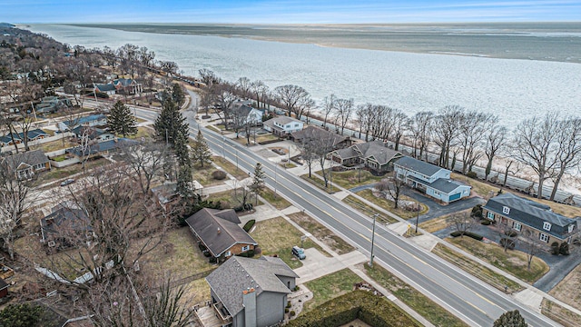 drone / aerial view with a residential view and a water view