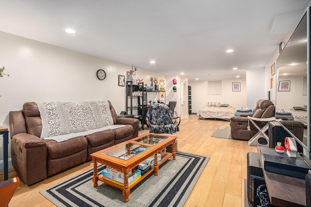 living room with light wood-style floors and recessed lighting