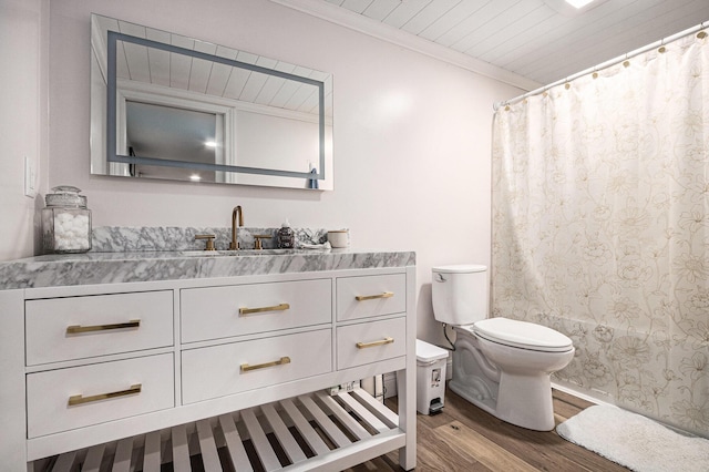 full bath featuring curtained shower, toilet, wood finished floors, vanity, and crown molding