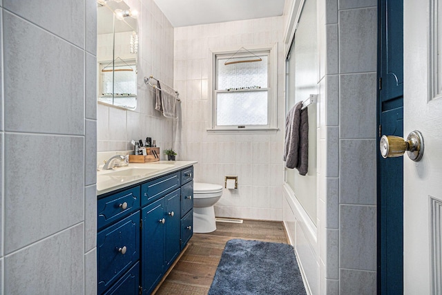 bathroom with vanity, tile walls, toilet, and wood finished floors