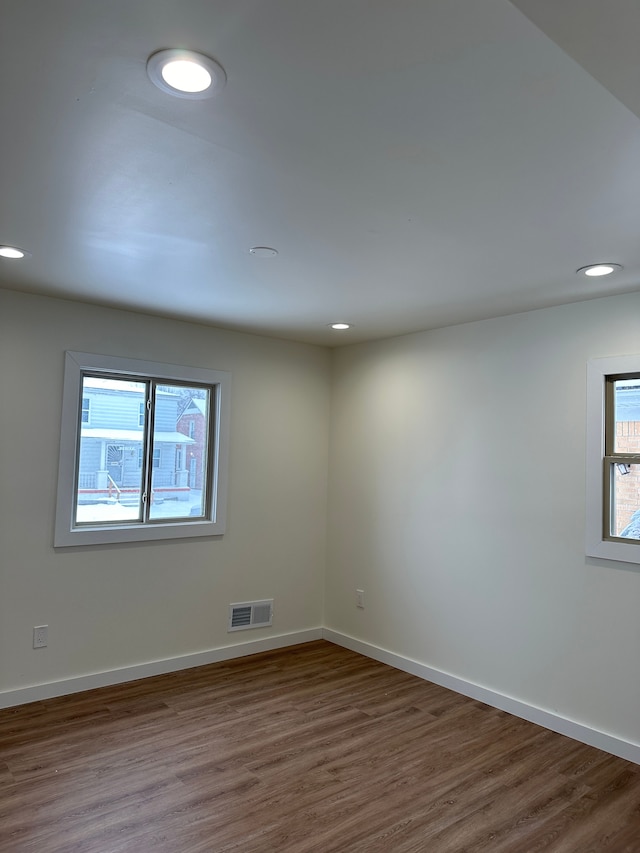 unfurnished room with recessed lighting, visible vents, baseboards, and wood finished floors