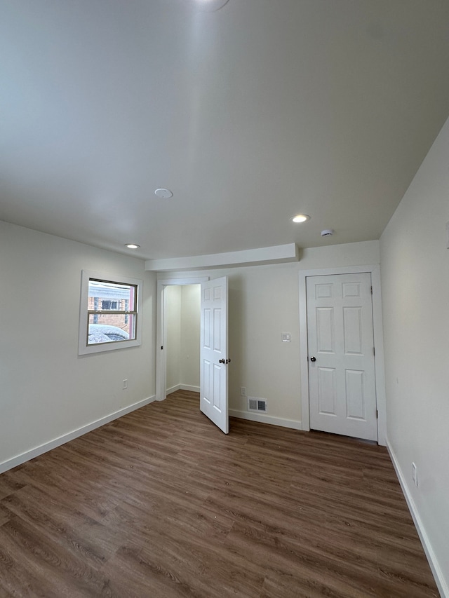 unfurnished bedroom with dark wood-style flooring, recessed lighting, visible vents, and baseboards