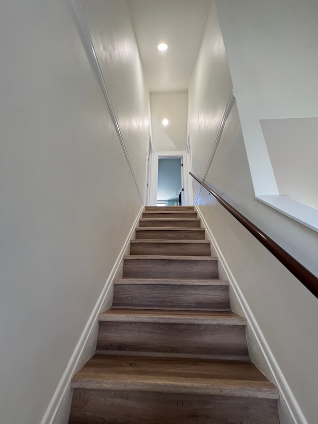 stairway with baseboards and recessed lighting