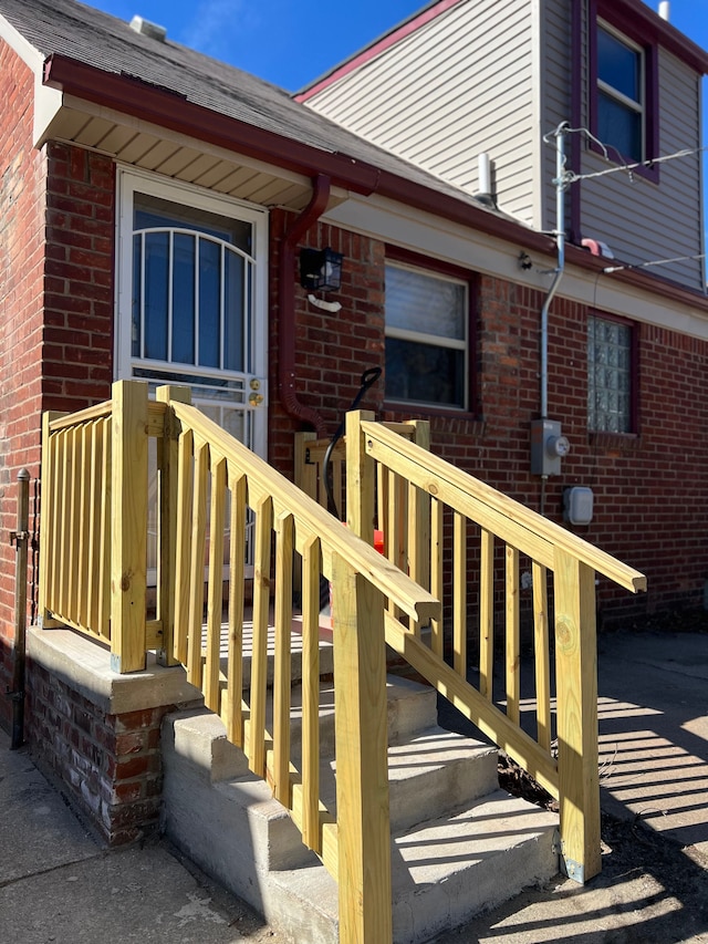 property entrance featuring brick siding