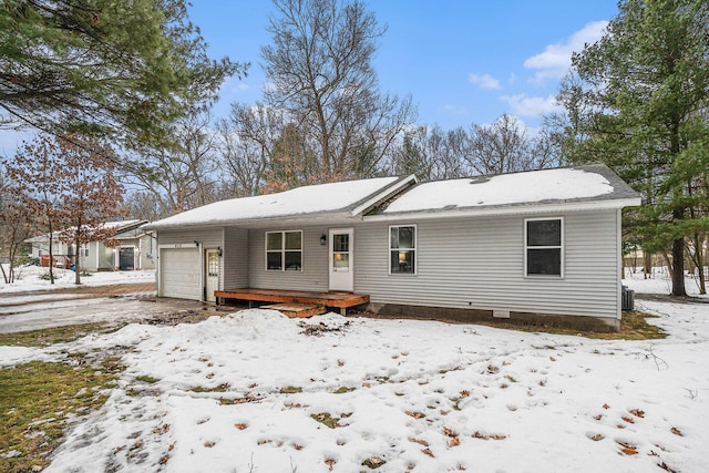 view of front of home with an attached garage and central air condition unit