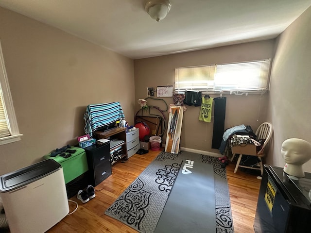 bedroom featuring light wood-type flooring and baseboards