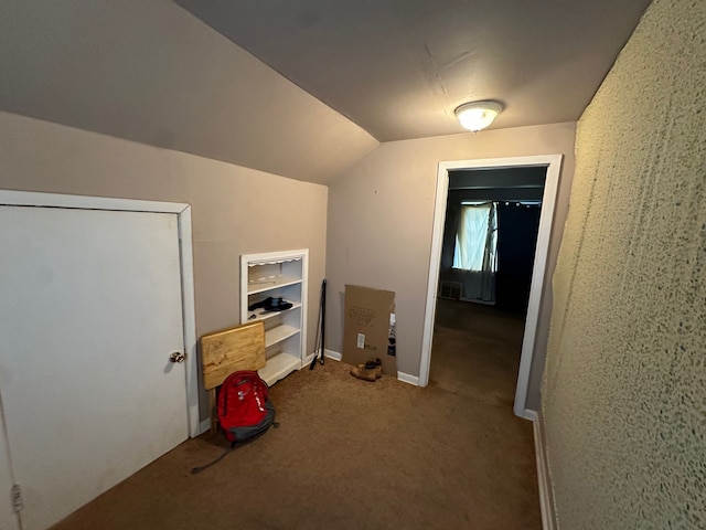 bonus room with carpet floors and vaulted ceiling