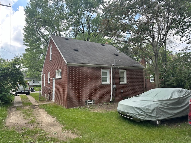 view of side of property featuring roof with shingles and brick siding