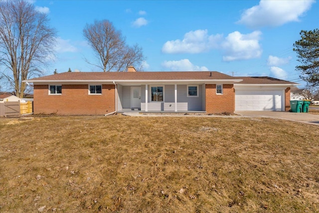 ranch-style home featuring a chimney, concrete driveway, a front lawn, a garage, and brick siding