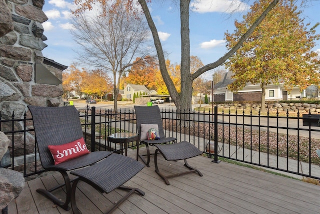 deck with a residential view and fence