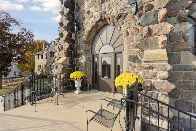 entrance to property featuring stone siding