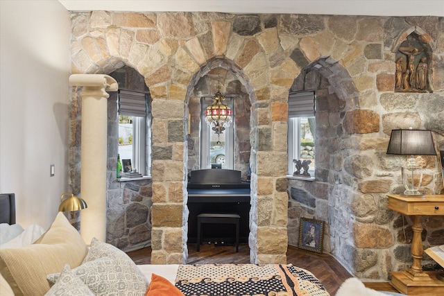 living area featuring a wood stove, a wealth of natural light, and wood finished floors