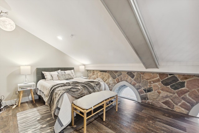 bedroom with vaulted ceiling and wood finished floors