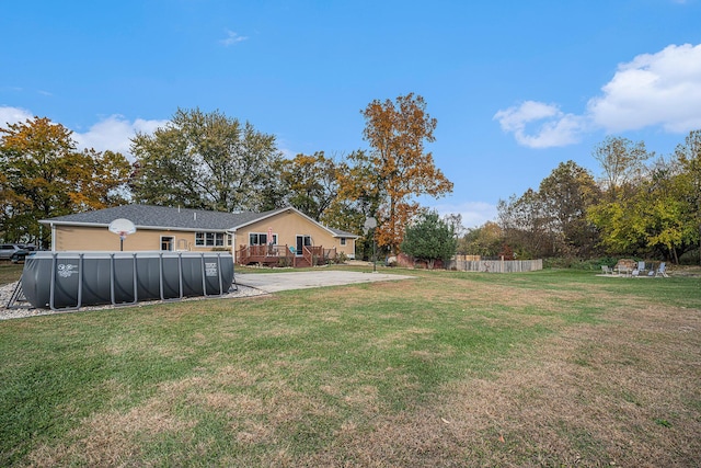 view of yard featuring an outdoor pool and fence