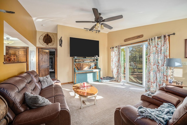 living area featuring carpet floors, ceiling fan, and baseboards