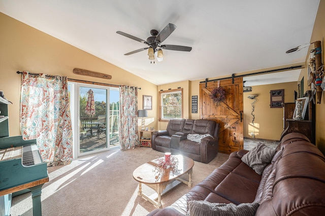 living room with a ceiling fan, lofted ceiling, carpet flooring, and a barn door