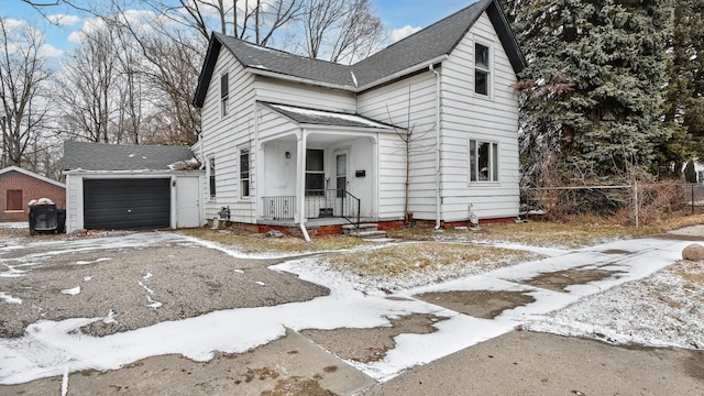 view of front of property featuring roof with shingles and fence