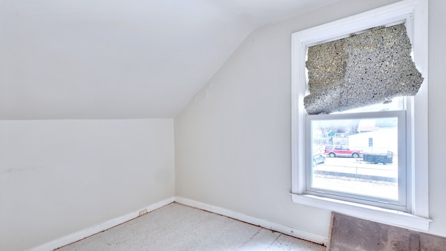 bonus room featuring lofted ceiling and baseboards