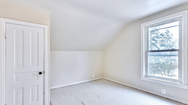 additional living space featuring lofted ceiling