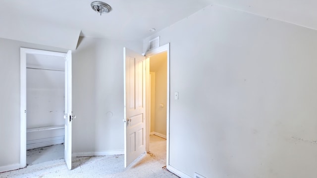 unfurnished bedroom with baseboards, visible vents, and a closet