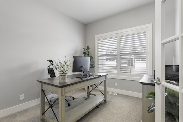 office space with light carpet and baseboards