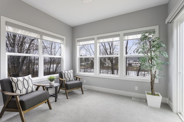 living area with carpet floors, baseboards, and visible vents