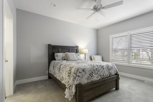 bedroom featuring a ceiling fan, carpet, and baseboards