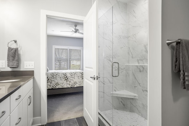 ensuite bathroom with a shower stall, vanity, baseboards, and ensuite bathroom