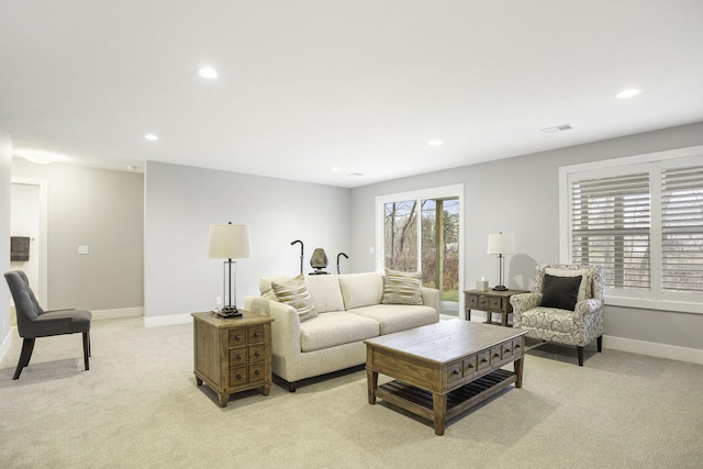 living area featuring light carpet, baseboards, visible vents, and recessed lighting