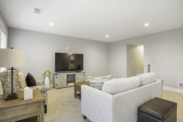 living room with recessed lighting, visible vents, baseboards, and light colored carpet