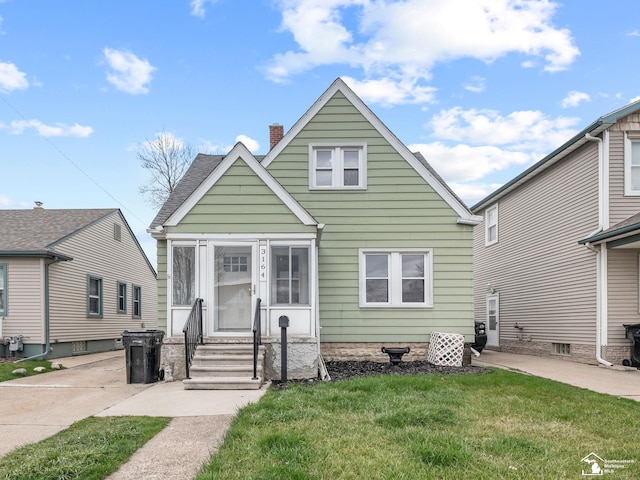 bungalow-style home featuring a chimney and a front lawn