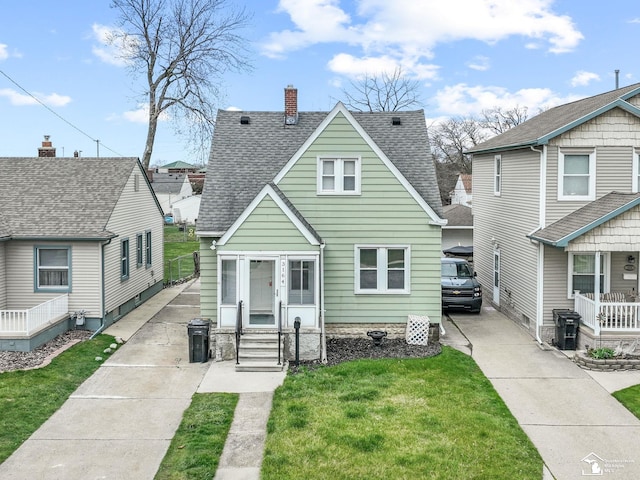 bungalow featuring roof with shingles, a chimney, and a front lawn