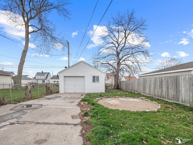 detached garage with driveway and fence