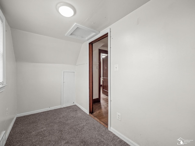 bonus room featuring carpet floors, visible vents, baseboards, vaulted ceiling, and attic access