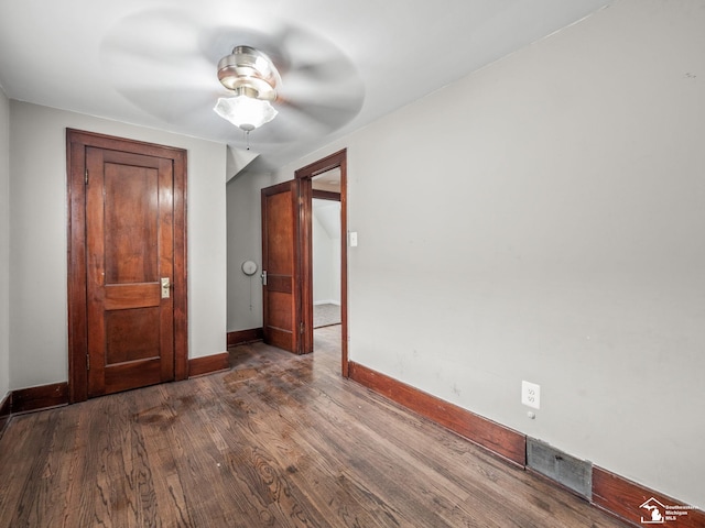 unfurnished bedroom featuring visible vents, dark wood finished floors, baseboards, and ceiling fan