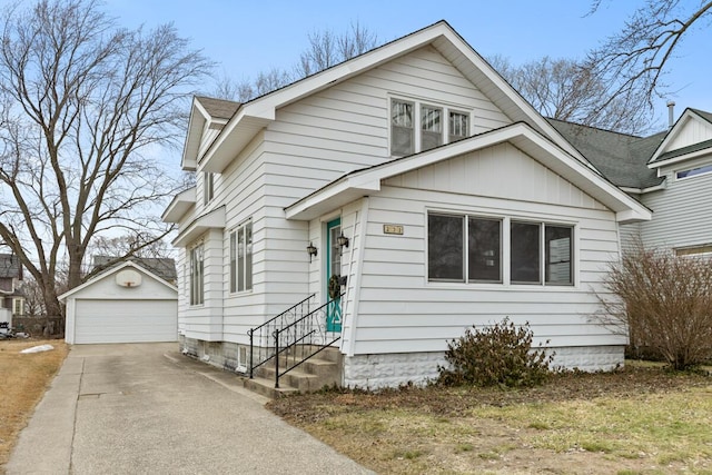 bungalow featuring a garage, entry steps, and an outdoor structure