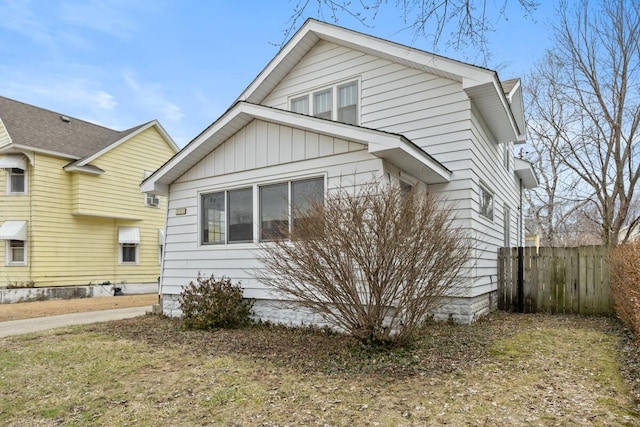 bungalow-style house with fence