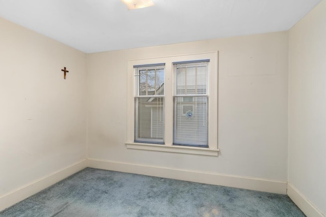 unfurnished room featuring carpet flooring and baseboards