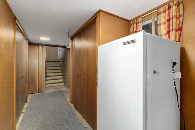 corridor with stairs and wooden walls