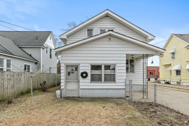 back of property featuring a fenced backyard