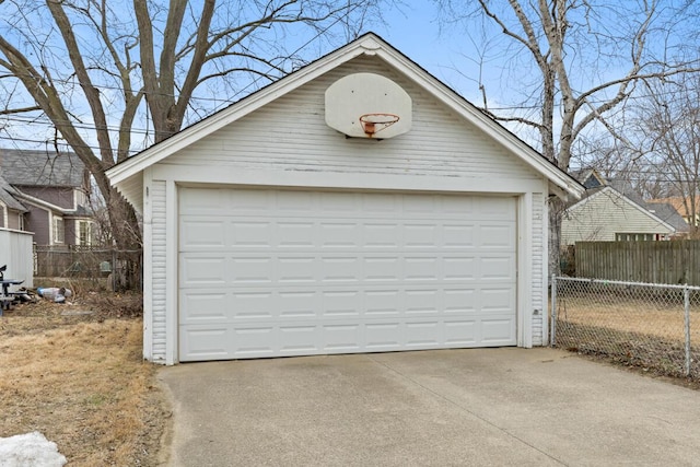 detached garage featuring fence