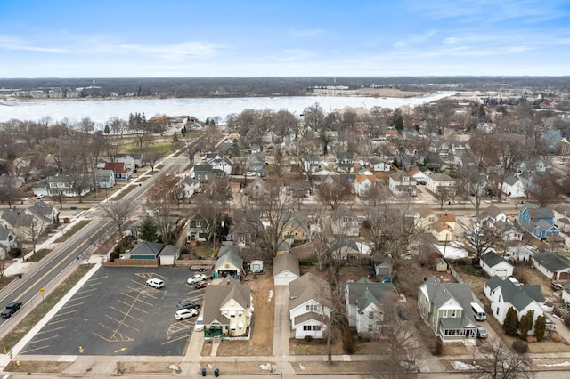 drone / aerial view featuring a water view and a residential view